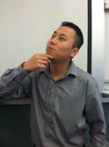 Teacher Johnny Nguyen poses in his science classroom