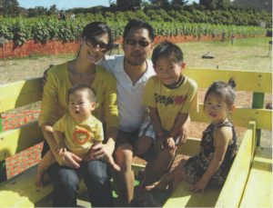 Alice Roh relaxes with her husband and kids at an orange grove.