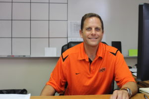 Assistant Principal Kevin Brown reads his email from his office in House B  