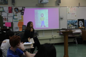 English teacher Julie Goler teaches her sixth period English Honors ¾ class with a PowerPoint from the book, The Canterbury Tales, she is describing. 