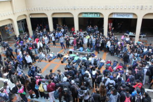 Normans lie on the ground, holding up signs in protest. Photo by: ELIAS IRAHETA