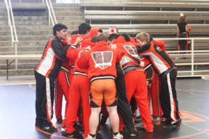 Varsity wrestler Gregory Yaroshevsky leads his team in a pre-grame chant before their tournament.