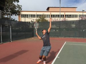 Junior Adriano Saitta goes into his serving motion. Photo by: LUCAS HARWARD