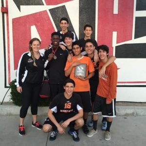 Boys varsity players and coach Sarah McCabe pose with their 2nd place plaque. Photo courtesy of: GUY GINSBERG