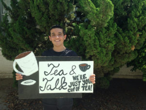 Sophomore Daniel Kohanbash holds the sign he used on club day to promote his new club, Tea & Talk. The new club got 100 sign ups on club day.