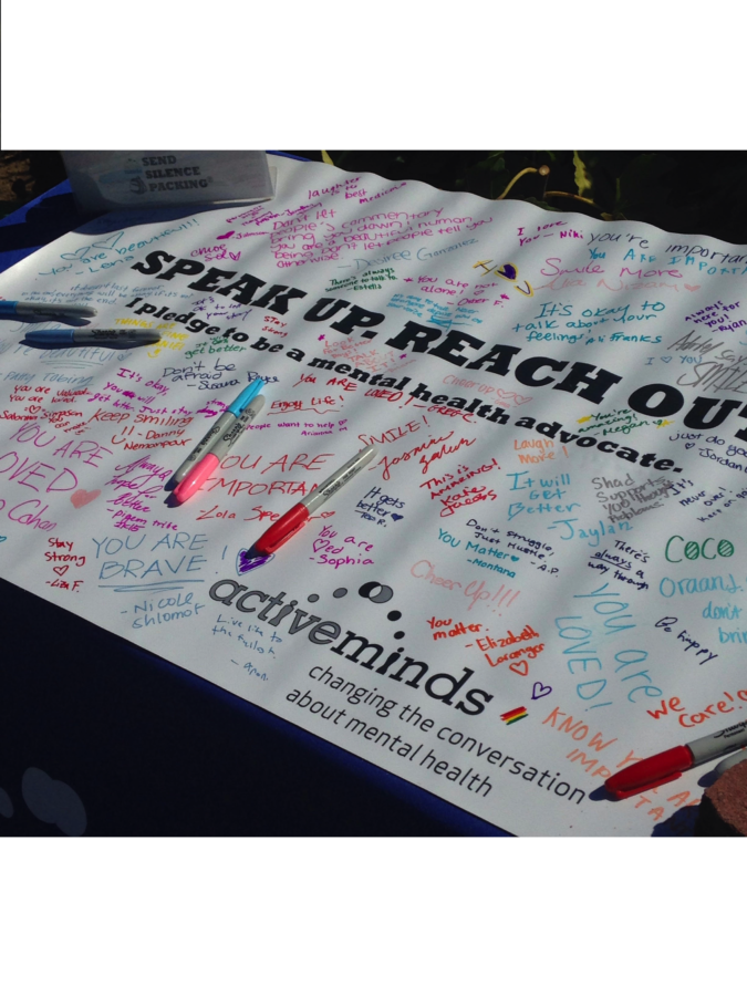 While walking around the front lawn, students offer supportive words to those suffering from mental health issues.