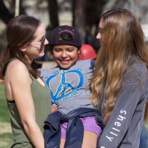 Schwartz and co-counselor Grace Ewell playing with one of the campers. 