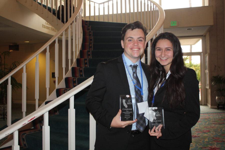 Senior Jake Wolken poses with his girlfriend Jackie Hauser as they flaunt their third place glass trophies in Hospitality and Team Decision Making at the 2016 State Career Development Conference.