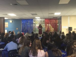 A crowd watches as sophomore Kate Blaylock performs a classic French song. 