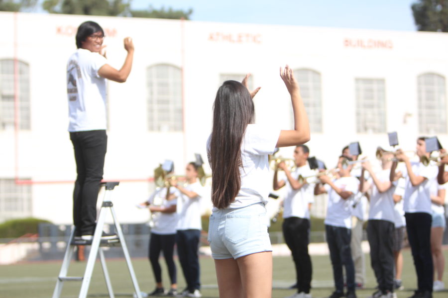 Brandon and Yoona Lee sync their composing during the Homecoming assembly on Oct. 7. Photo courtesy of: WATCHTOWER.