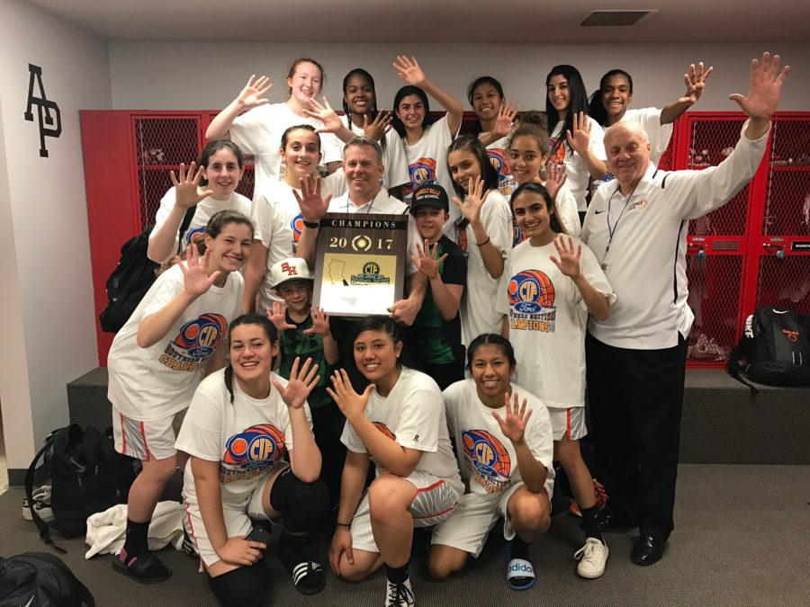 The triumphant girls varsity basketball team celebrates their CIF win.