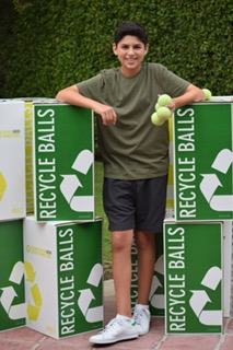 Sophomore Jason Mandel poses in front of Recycleballs' equipment.