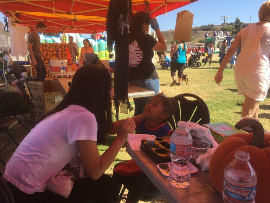 Interact Club volunteers at carnival for military-based kids