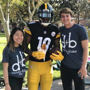 Debbie and Blake pose with Juju Smith-Schuster, a former USC football player and current member of the Pittsburgh Steelers.