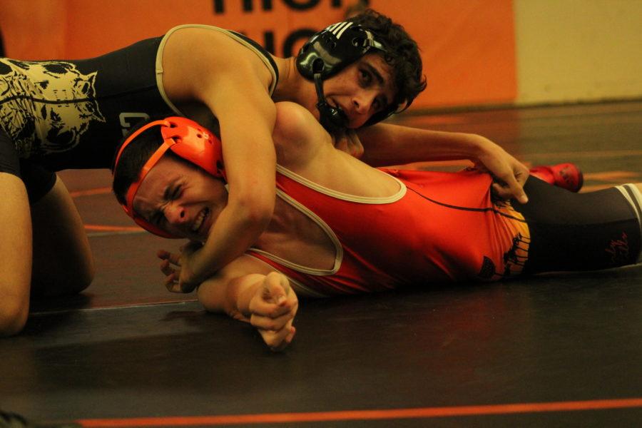Sophomore Koby Kranis attempts to get out of a pin imposed by his Calabasas opponent.