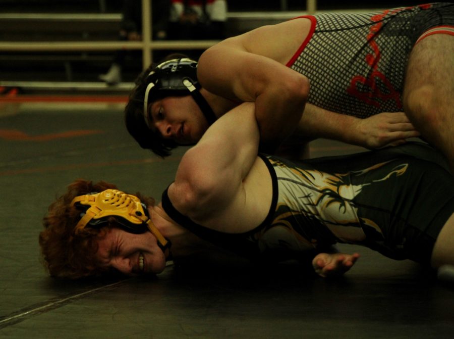 Senior co-captain Tommy Golin holds his opponent in a pin during the duel versus the Mira Costa Mustangs.