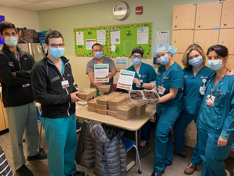 Photo of medical workers with donated food, courtesy of Meal to Heal.
