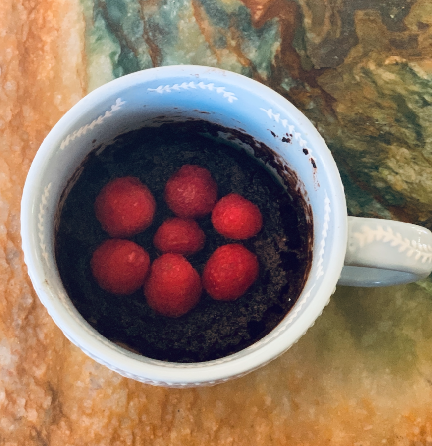 Photo of chocolate mug cake topped with raspberries