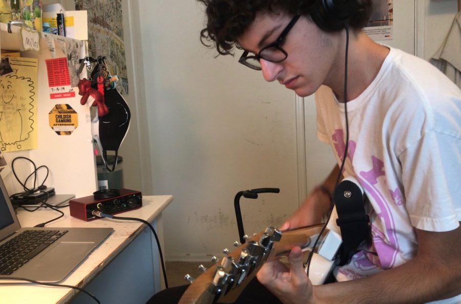 Junior Miles Platt plays his guitar and records music through a Focusrite Scarlett 2i2 interface. Photo courtesy of Miles Platt.