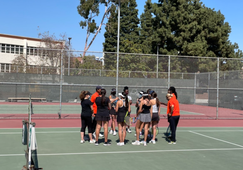 The tennis team is seen huddling up before the big match.