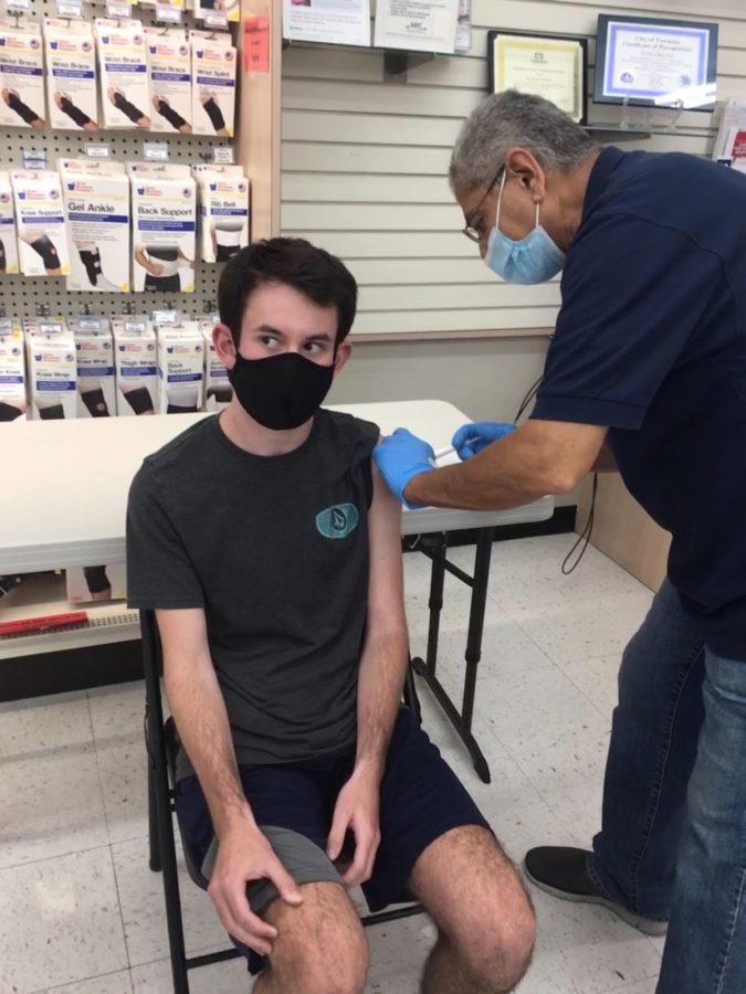 Senior Sam Wolf receives his first dose of the Pfizer vaccine.