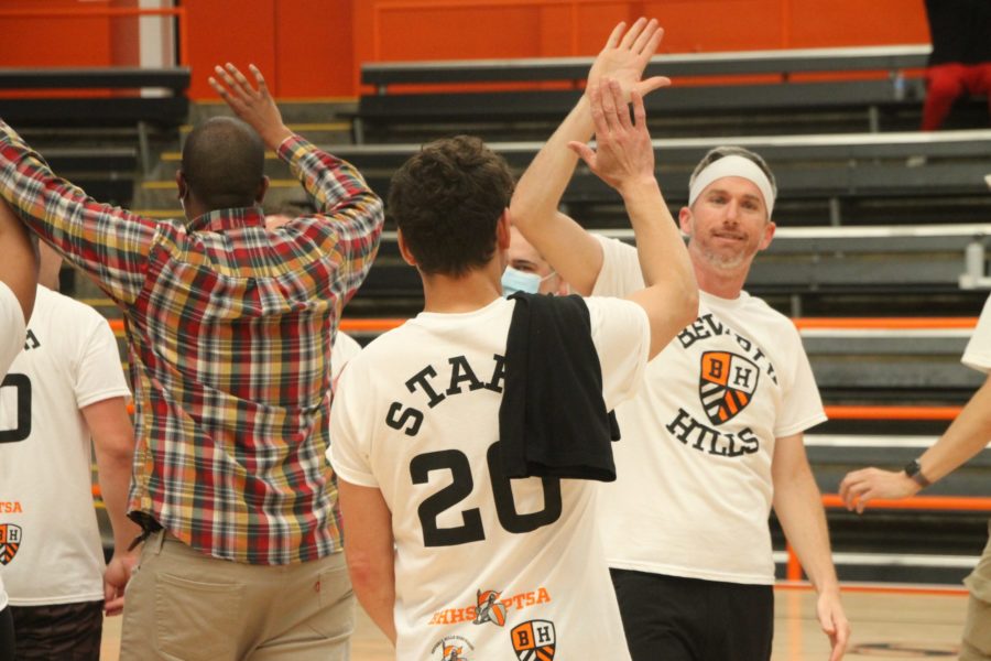 Math teacher Joshua Glass high-fives one of his teammates after their second time beating the seniors.