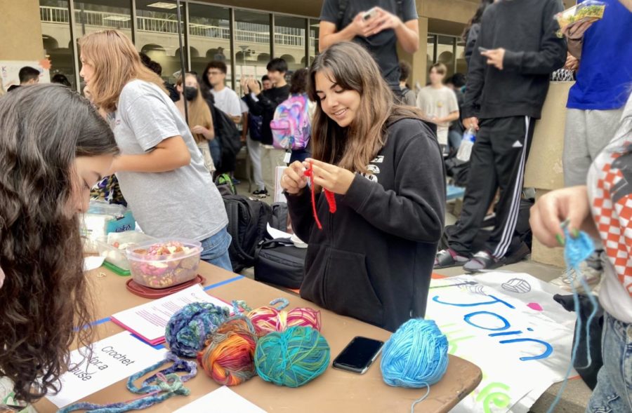 Leader of the Crochet for a Cause Club, junior Shayda Dadvand shows people interested in joining her club what exactly they do.
Photo by: Kate Oller