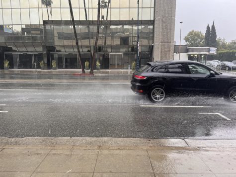 Car drives through pouring rain. 
