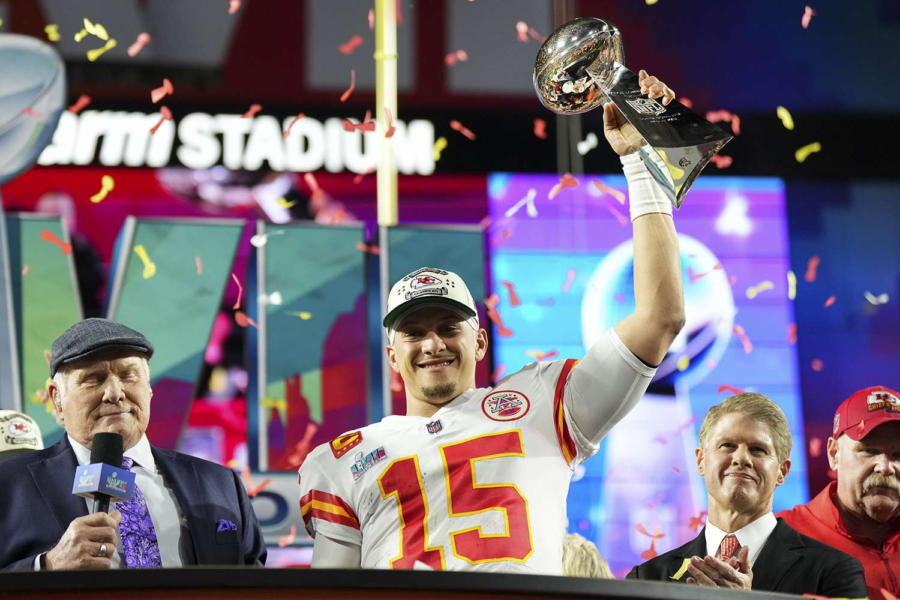 Patrick Mahomes raises the Super Bowl trophy after beating the Eagles. Photo from “People.com”