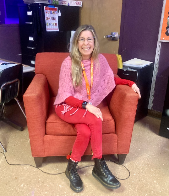 Ms. Karen Lagola sits in her Valentines outfit for Tuesday’s “Pink & Red Day.” Photo by: Kate Oller