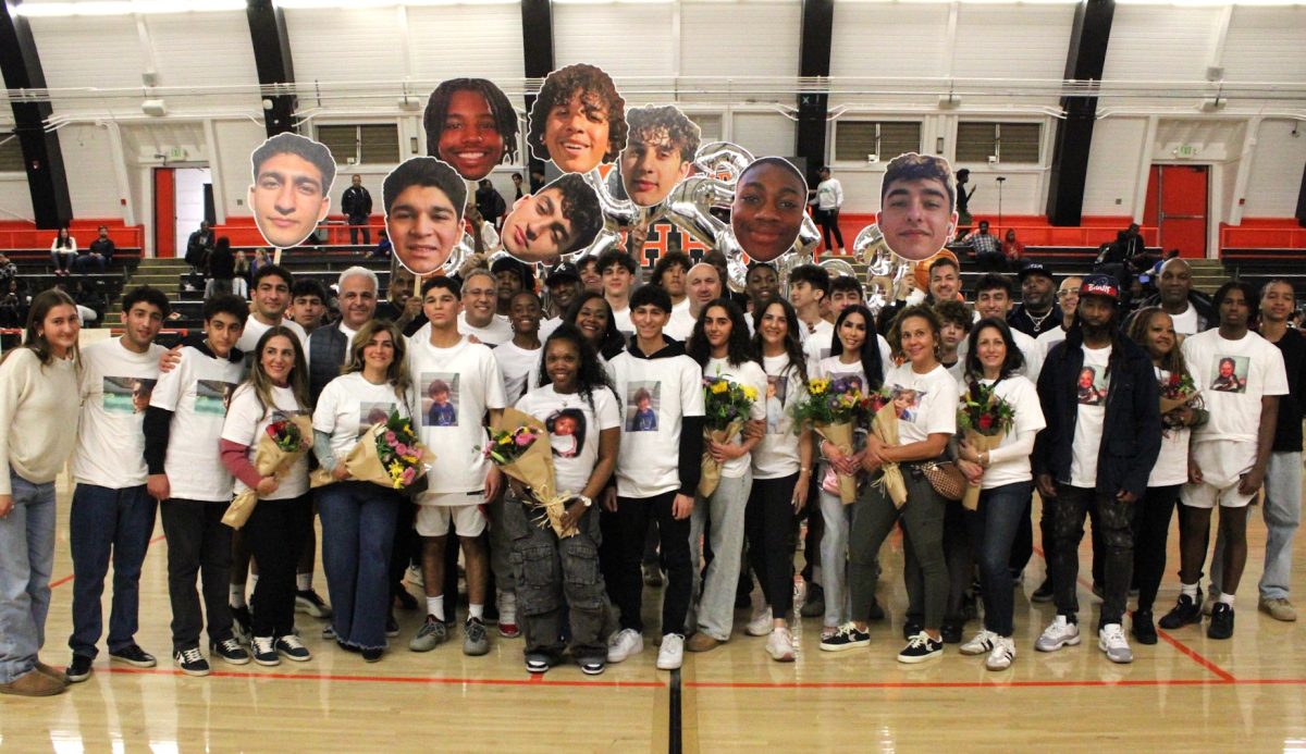 Beverly's boys varsity basketball team groups together with loved ones to celebrate their seniors 