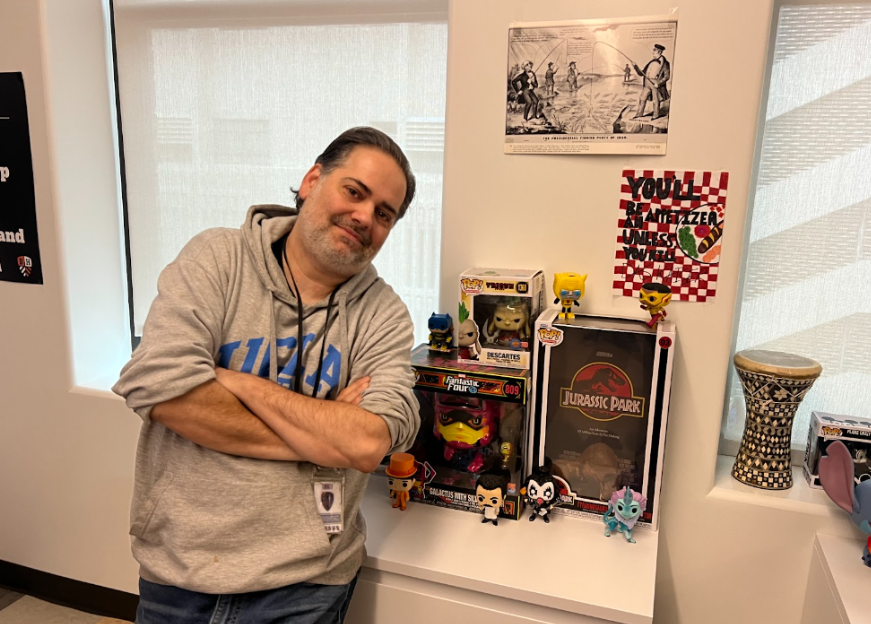 Mr. Dan Moroaica, standing with pride in front of some of his many Funko Pops. 
