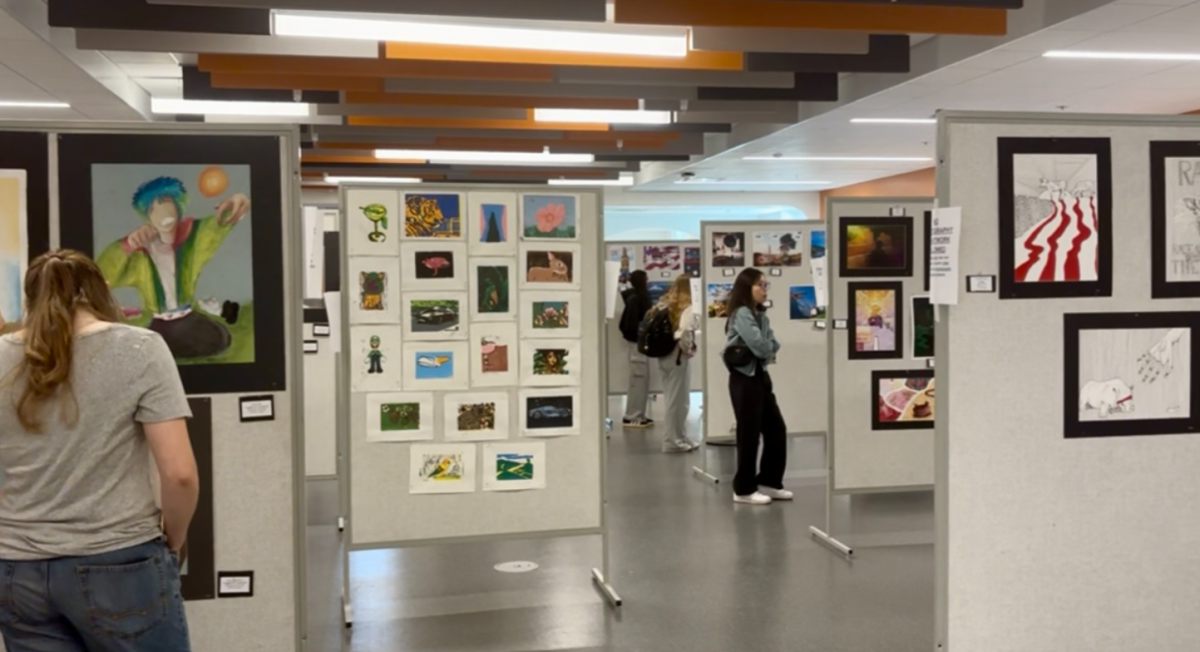 Students, family and faculty explore the variety of artwork showcased
