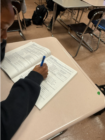 Freshman Kgali Rapia working on homework during office hours.