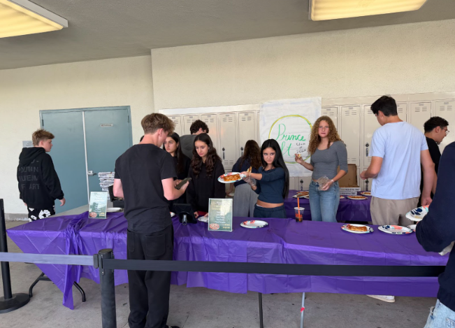 The sophomores hosting the Prince Street Pizza station.
