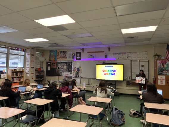 Students work on writing prompts during a Creative Writing Club meeting.
