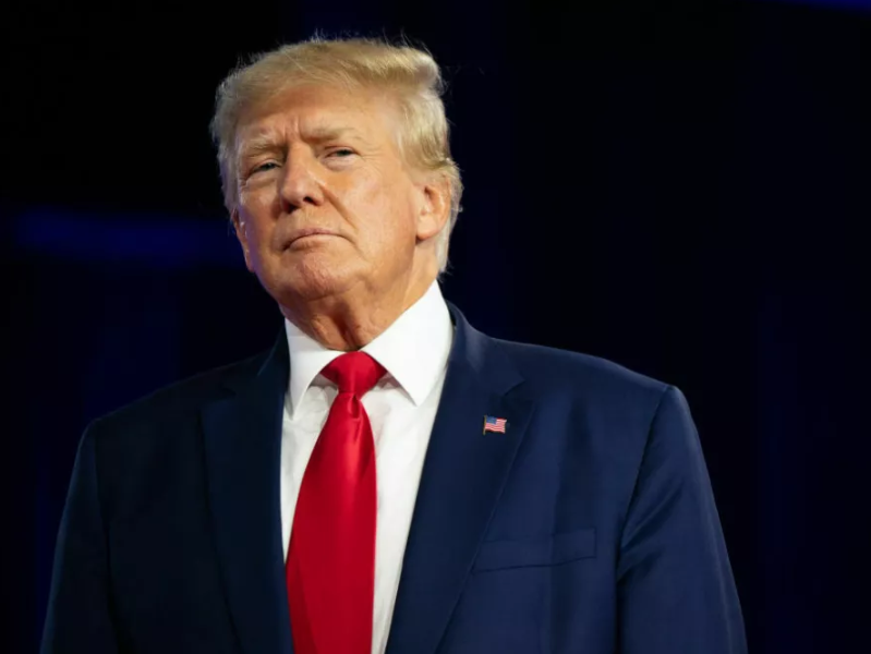 President Donald Trump stands onstage.