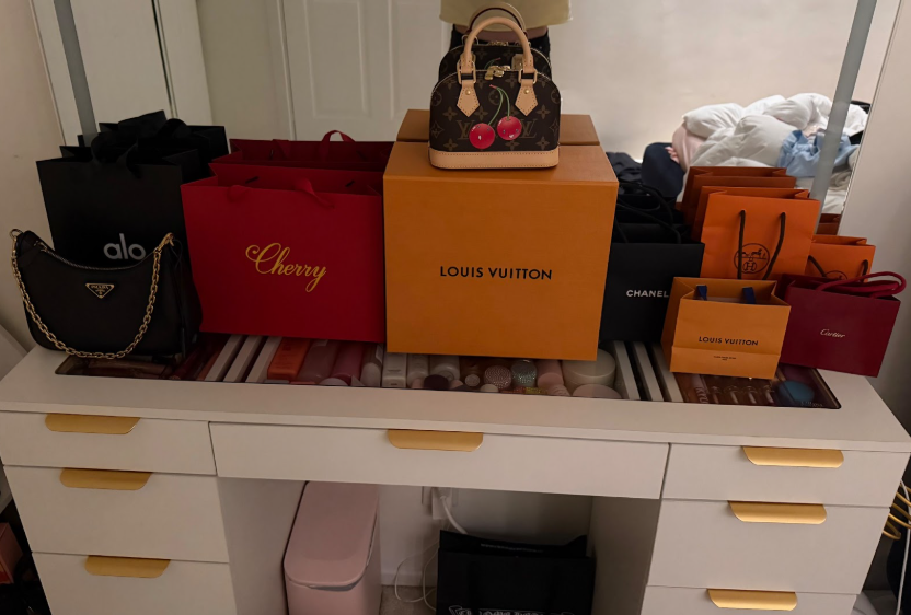 Designer bags placed on a table after a big purchase.